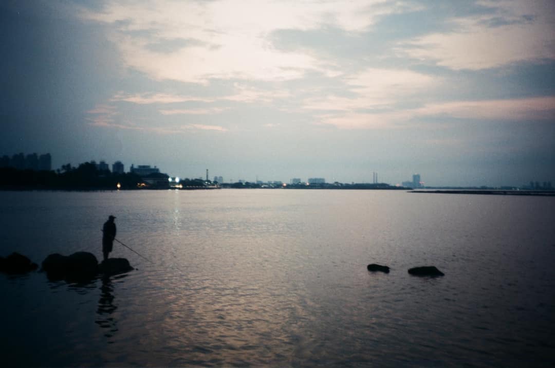 Solitary Evening Fisherman by the Harbour